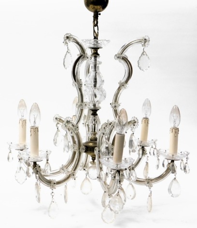 A 20thC cut glass and brass six branch chandelier, with tear and icicle shaped drops, 47cm high.