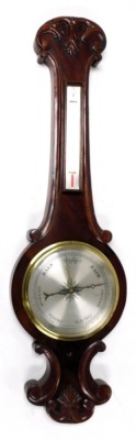 A Victorian mahogany wheel barometer, with thermometer, the case with foliate carved decoration, 92cm high.