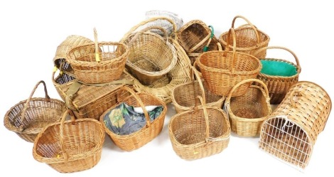 A group of wicker baskets, picnic box, and a cat basket. (under 2 tables)