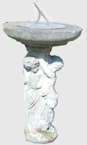 A figural concrete and copper sundial, the octagonal sundial raised on a circular top, above a pair of putti, on a circular base, 65cm high, 45cm diameter.