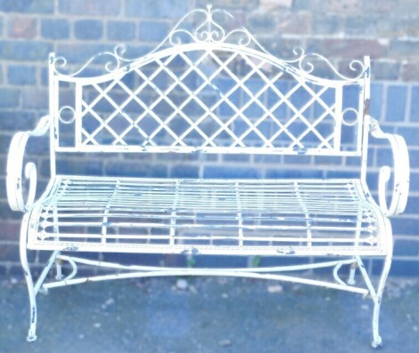 A Victorian style white painted cast iron two seater bench, 115cm wide.