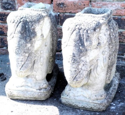 A pair of concrete planters, modelled as Indian elephants, raised on a rectangular base, 5cm high, 50cm deep.