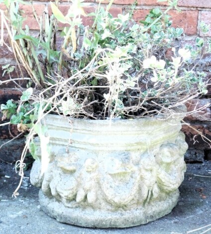 An octagonal garden planter, decorated with a band of putti and laurel swags, 40cm wide.