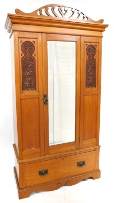 A Victorian satin walnut double wardrobe, with a scroll carved pediment, above a central door with rectangular bevelled mirror glass plate, flanked by fruit and flower carved panels, opening to reveal a hanging rail and hooks, above a frieze drawer, raise - 3