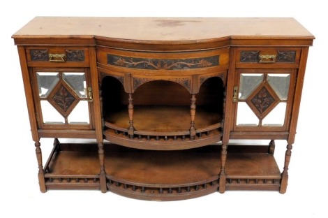 A Victorian mahogany bow front sideboard, with a vine carved frieze, above a central galleried recess with turned supports, flanked by a pair of frieze drawers over glass panelled doors, raised on turned legs united by a galleried under tier, 98cm high, 1