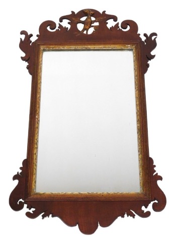 A Georgian style mahogany and parcel gilt fret work wall mirror, the surmount carved with a ho-ho bird, with a rectangular glass plate, 77cm high, 44cm wide.