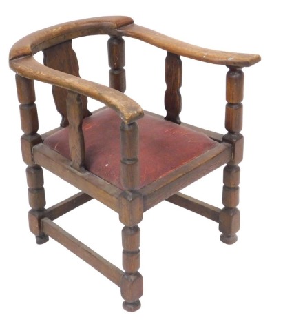 An early 20thC oak rustic smoker's bow chair, raised on turned legs united by stretchers, 52cm wide.