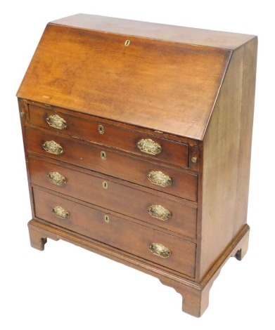 A George III oak bureau, the fall flap opening to reveal a central door flanked by two recesses and six drawers, over four long graduated drawers, raised on bracket feet, 120cm high, 94cm wide, 52cm deep.