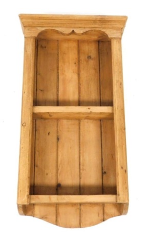 A Victorian pine wall hanging shelf, with an outswept pediment, above two shelves, 86cm high, 45cm wide, 16cm deep.