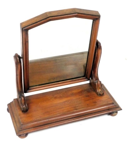 A Victorian mahogany swing framed toilet mirror, raised on an outswept rectangular base, on bun feet, 55cm high, 53cm wide, 23cm deep.