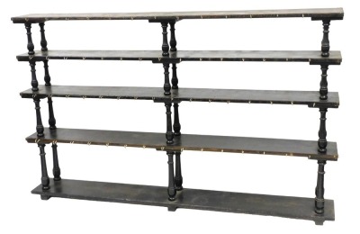 A set of 19thC oak shelves, having four shelves united by turned supports, and fronted by later hooks, 134cm high, 216cm wide, 27.5cm deep.