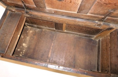 A 17thC oak coffer, with a triple panelled lid, above a carved frieze and floral panelled front, raised on stiles, 49cm high, 106cm wide, 45cm deep. - 3