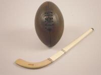 A miniature Hazell's Adroit hockey stick and a miniature brown leather rugby ball (2). The hockey s