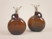 A pair of Victorian brown glass whiskey decanters