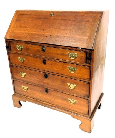 A George III oak bureau, the fall flap opening to reveal one short and two long drawers, above eight recesses, and a central cupboard door above four further drawers, over four long graduated drawers, raised on bracket feet, 113cm high, 92cm wide, 47cm de