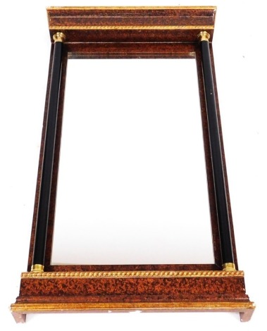 A French Empire style scumbled and giltwood wall mirror, with a rectangular glass plate, and two brass capped ebonised columns, raised on a plinth base, 108cm x 59cm.