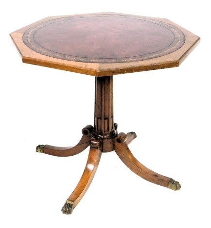 An Angelo Romano Limited Regency style mahogany occasional table, with a tooled leather inset octagonal top, raised on a reeded column over four out swept legs, brass capped, stamped marks to underside, 70cm high, 77cm wide.