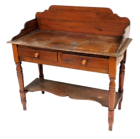 A Victorian stained pine wash stand, with two frieze drawers, raised on turned legs united by an under tier, 100cm high, 104cm wide, 46cm deep.