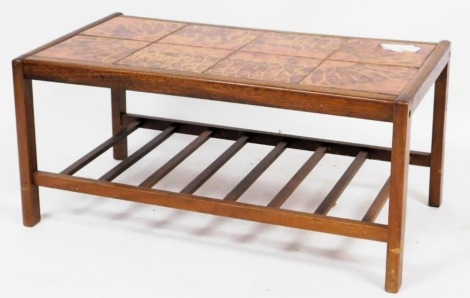 A mid century teak and tile top coffee table, of rectangular section, raised on square legs united by a slatted under tier, 40cm high, 86cm wide, 49cm deep.