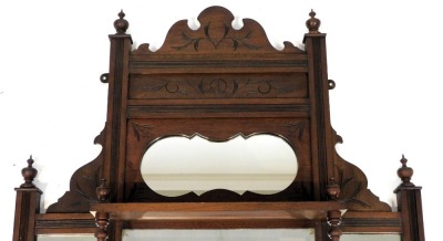 A Victorian mahogany framed overmantel mirror, with a carved pediment above floral carving and a shaped mirror, rectangular glass plate, flanked by two further glass plates with shelves to the front, 101cm x 74cm. - 2