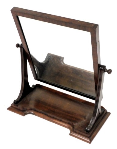 A Victorian mahogany swing frame toilet mirror, with a rectangular glass plate, raised on a shaped base, 68.5cm x 59.5cm.