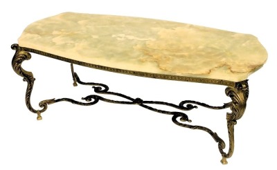 A late 20thC onyx and brass coffee table, with a serpentine top, raised on four leaf scroll cabriole legs, united by a X shaped stretcher, 45cm high, 115cm wide, 58cm deep.