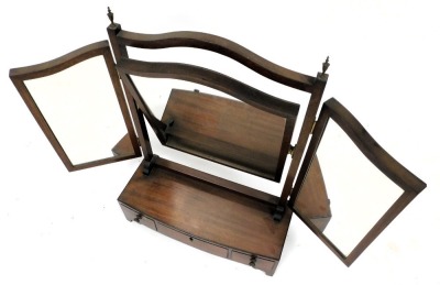 A George III mahogany toilet mirror, with a triptych mirror, over a bow fronted base with one long and two short drawers, raised on bracket feet, 68cm high, 48.5cm wide, 20cm deep. - 2