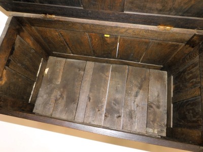 A 17thC style oak blanket chest, with a panelled lid, the front with foliate carving, raised on stiles, 54cm high, 94cm wide, 47cm deep. - 3