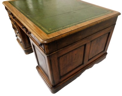 A Victorian mahogany partner's desk, with a gilt tooled green leather top, above one long and two short drawers, raised on a pedestal with three further drawers, the other with a cupboard door, the same to the other side, raised on plinth bases, 77cm high - 4