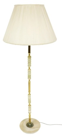 A late 20thC brass and onyx standard lamp, with an ivory silk shade, 152cm high. Buyer Note: WARNING! This lot contains untested or unsafe electrical items. It is supplied for scrap or reconditioning only. TRADE ONLY