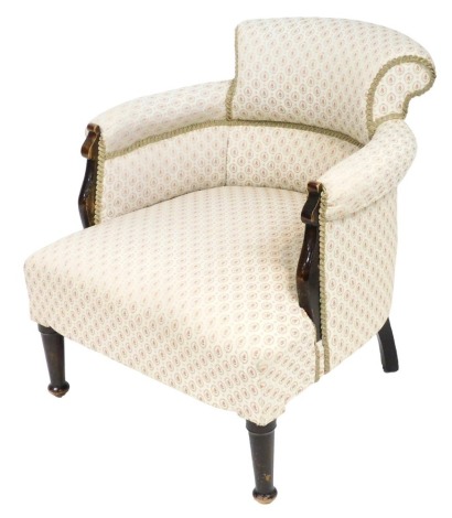 A Victorian oak tub nursing chair, upholstered in rose floral cream fabric, raised on turned legs, 68cm wide.