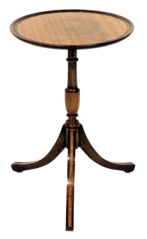 A Georgian style mahogany wine table, with satinwood banding and boxwood line inlay, the circular top raised on a turned column over three out swept legs, 55cm high, 35cm diameter.