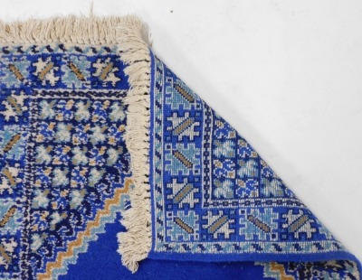 A Moroccan blue ground rug, the central field with a single medallion, within repeating geometric borders, 160cm x 83cm. - 2