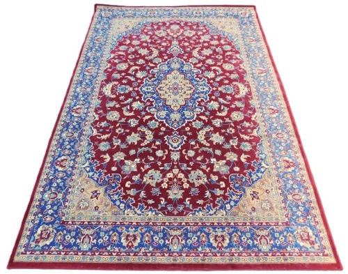 An Ikea Vedak Egyptian red ground rug, with a central floral medallion, on a field of flowers, within repeating floral borders, 200cm x 300cm.