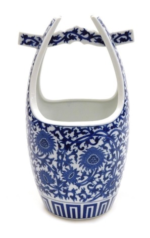 A blue and white porcelain water pail, decorated with flowers and scrolling leaves, probably Japanese, Meiji period, 32cm high.