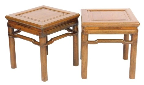 A pair of 19thC Chinese fruitwood and pine square tables, with recessed square moulded panelled tops, stylised stretchers and plain turned legs, 48cm high, 52cm wide, 48cm deep.