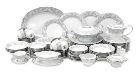 A Noritake porcelain Greycrest pattern dinner and tea service, comprising two graduated meat platters, vegetable tureen and cover, oval serving dish, sauce boat on integral stand, salt and pepper, eleven dinner, twelve dessert and eleven side plates, nine