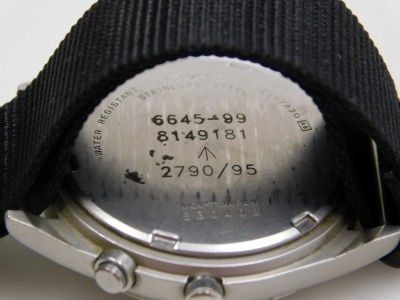 A Seiko British military chronograph watch, in stainless steel case with black dial, three subsidiary hands and date, with luminous Arabic numerals and hands, the case back numbered 6645-99 8149181 with broad arrow above 2790/95, serial number 530403, and - 3