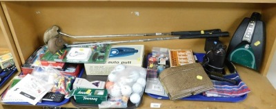 Golf related items, to include two clubs, tees, golf balls, an Auto Putt, etc. (1 shelf)