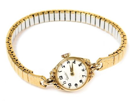 An Everite lady's 9ct gold cased wristwatch, circular white dial bearing Arabic numerals, on a plated strap.