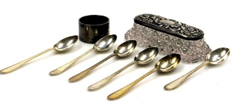 A set of six George V silver teaspoons, Sheffield 1922, George V silver napkin ring, Birmingham 1932, and a George V cut glass and silver lidded pin box, with embossed floral and foliate decoration, vacant reserve, Birmingham 1911, 4.69oz.