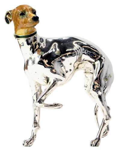 A silver and enamel figure modelled as a Greyhound, with front paw raised, wearing green collar, stamped 925, 15cm high.