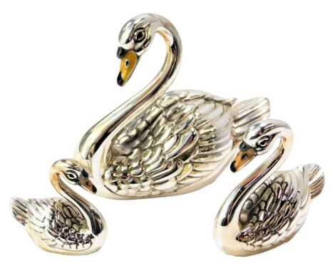 A graduated set of three silver and enamel figures modelled as swans, each stamped 925, 5.5cm high, 4cm high and 2.5cm high.