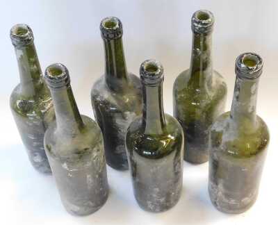 Six early 19thC green glass wine bottles, 30cm high. - 2