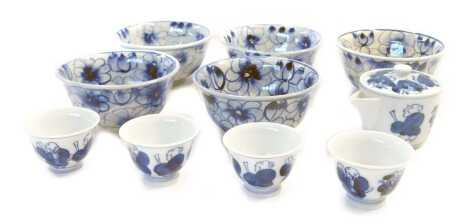 A 20thC Japanese blue and white teapot and four tea bowls, painted with figures, signed, and five Continental pottery fruit bowls, painted in blue and white with flowers. (10)