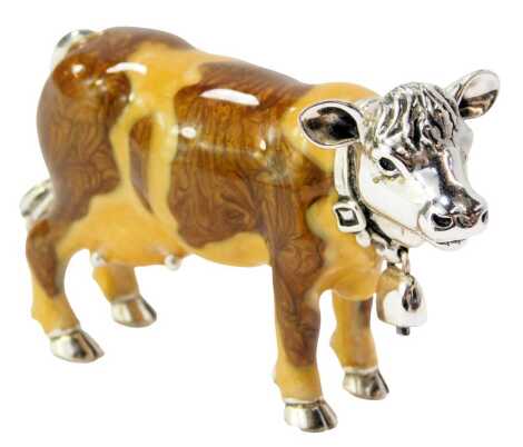 A silver and enamel figure modelled as a cow, with hanging bell collar, stamped 925, 4.5cm high.