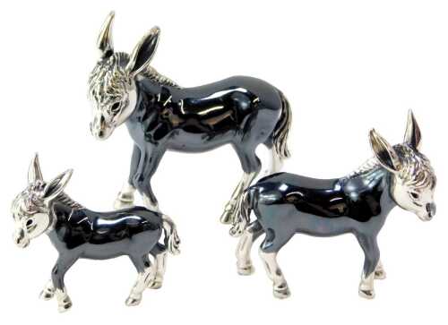 A graduated set of three silver figures modelled as donkeys, each stamped 925, 6cm high, 5cm high and 4cm high.