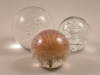 Two glass paperweights and a perspex weight