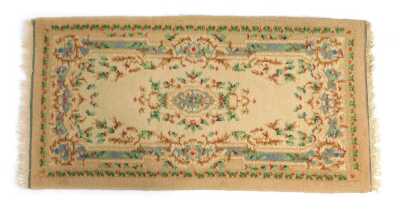 A French wool rug, decorated with flowers, on a cream ground, 154cm x 81cm.