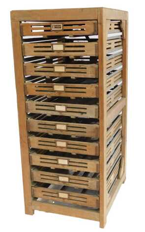 A 1940's French pine rack of ten sliding potato 'chitting' drawers, 139cm high, 58cm wide, 72cm deep.